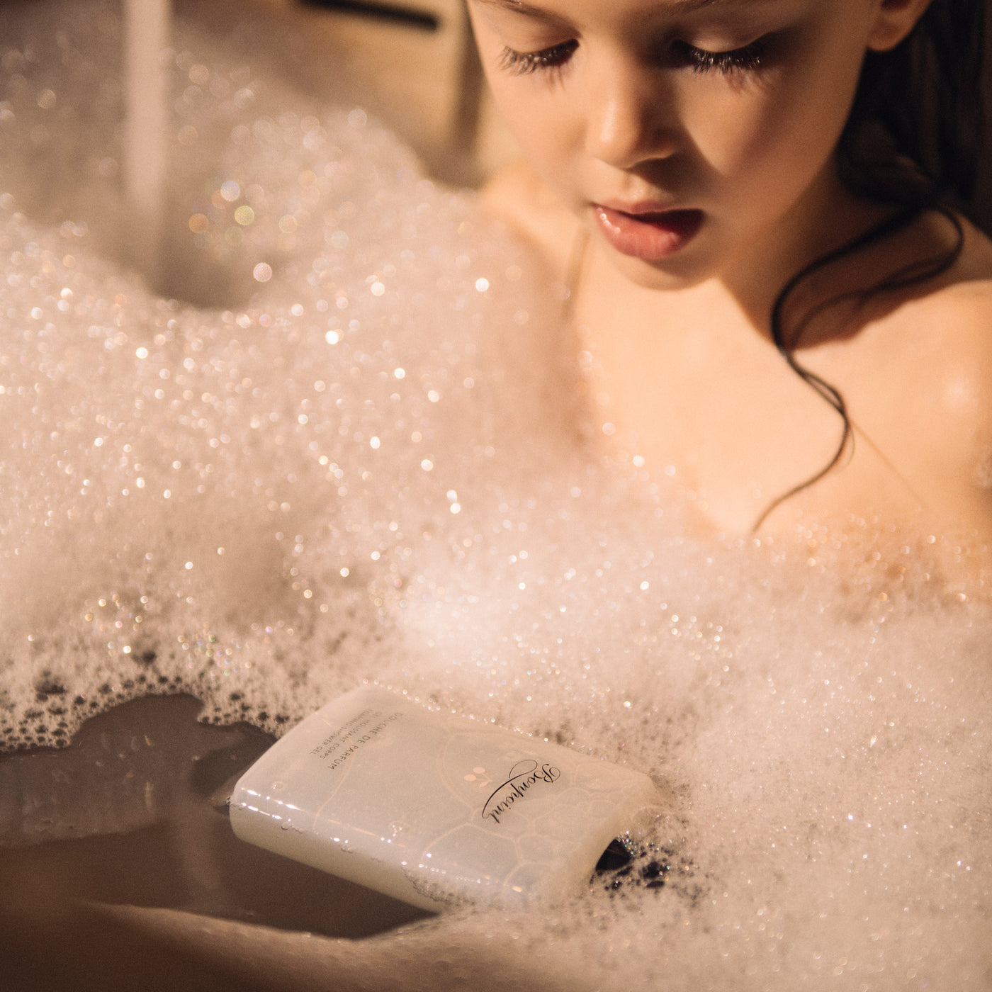 Little girl in bath with bubbles from Bonpoint soap