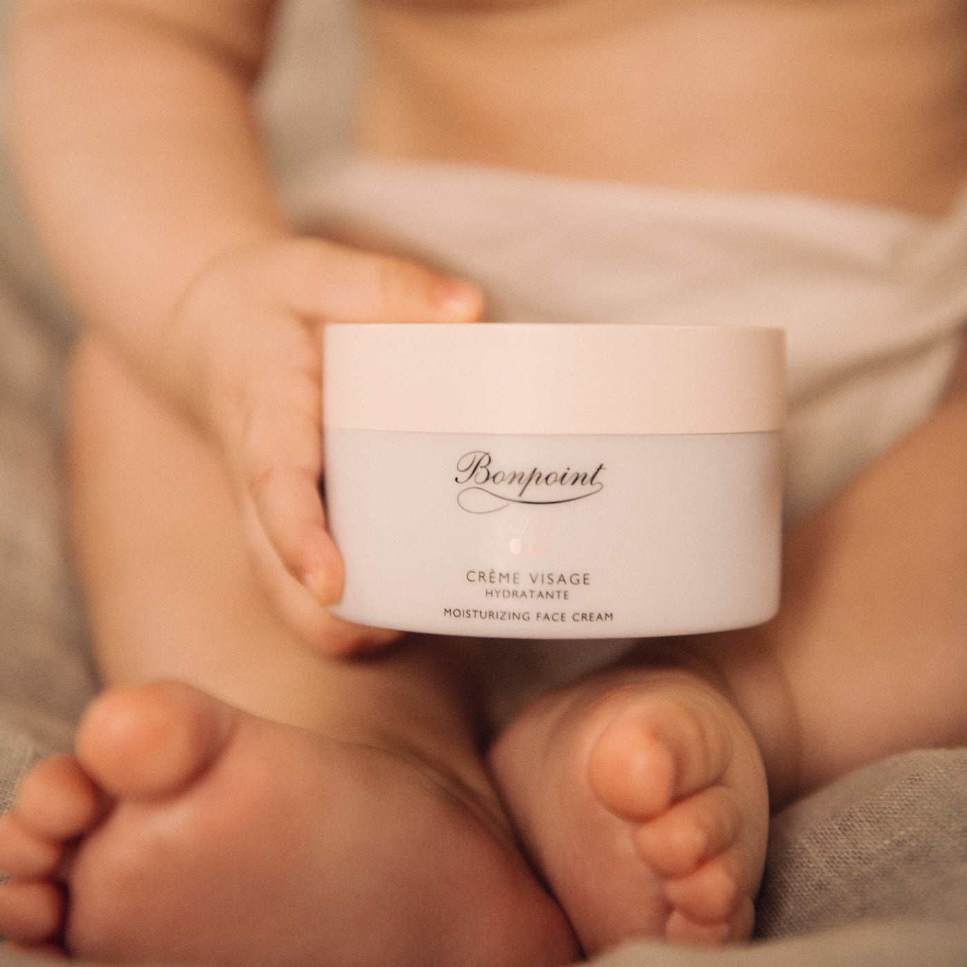 Baby holding Bonpoint cream