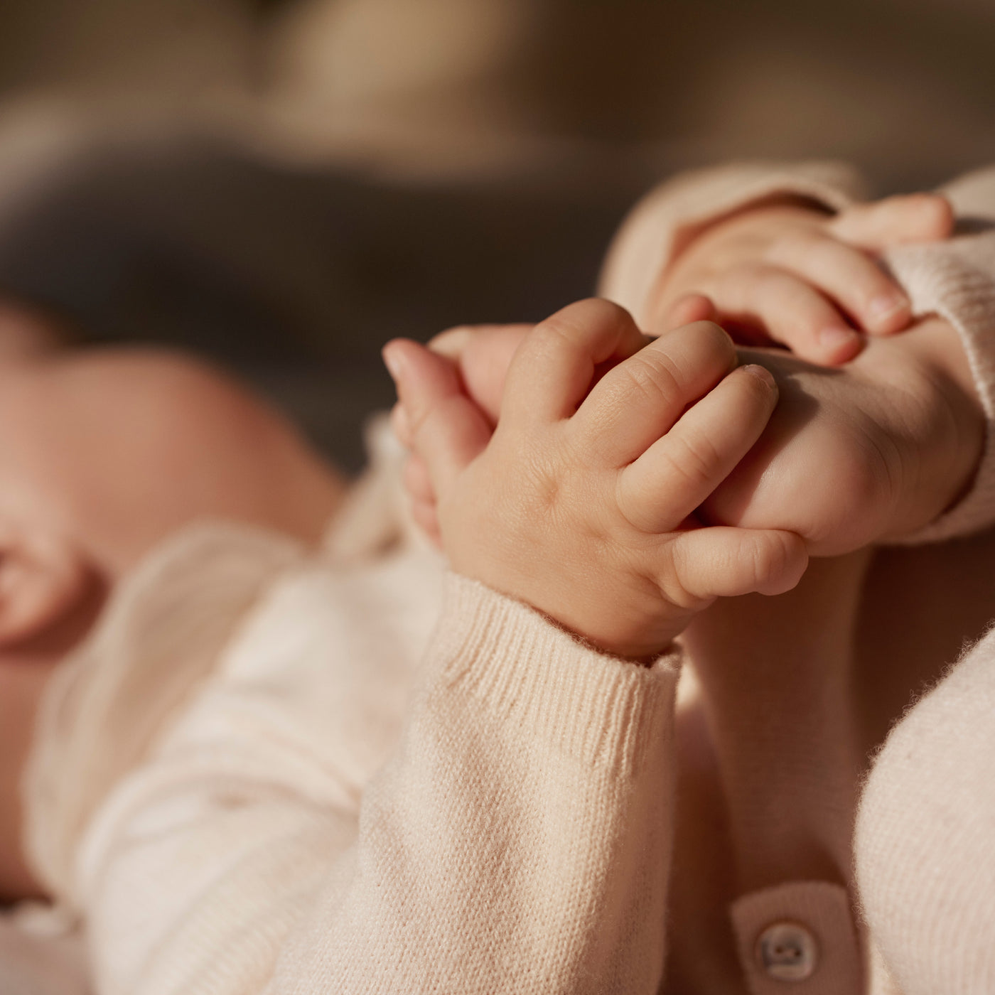 Bonpoint baby holding foot with hands