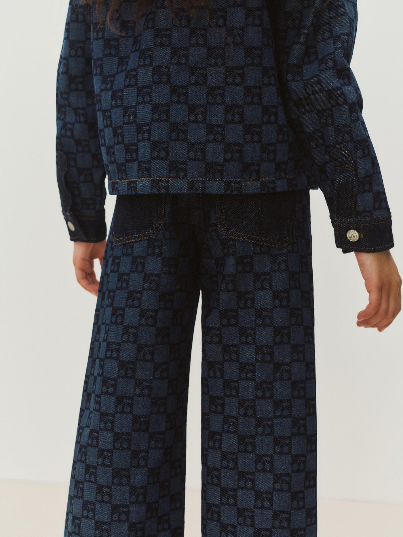 Minalie cherry checkerboard-print denim trousers in organic cotton