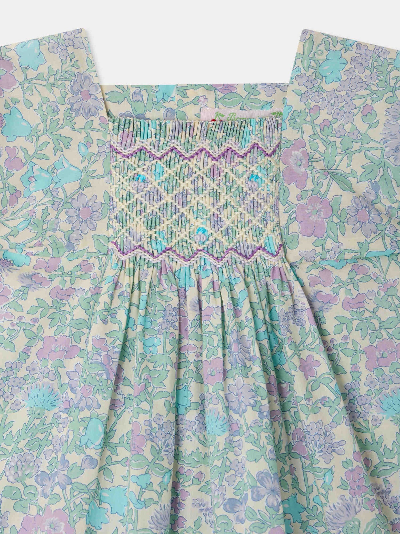 Smocked and hand-embroidered Pais dress in Liberty organic cotton fabric