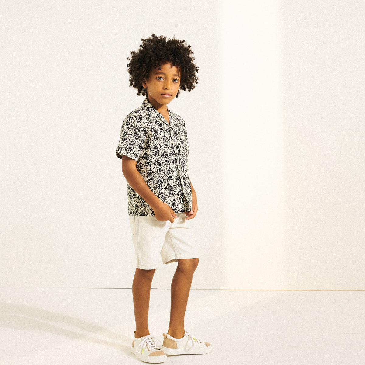 Boy in short sleeve button down shirt from Bonpoint Spring Summer 2022 Collection