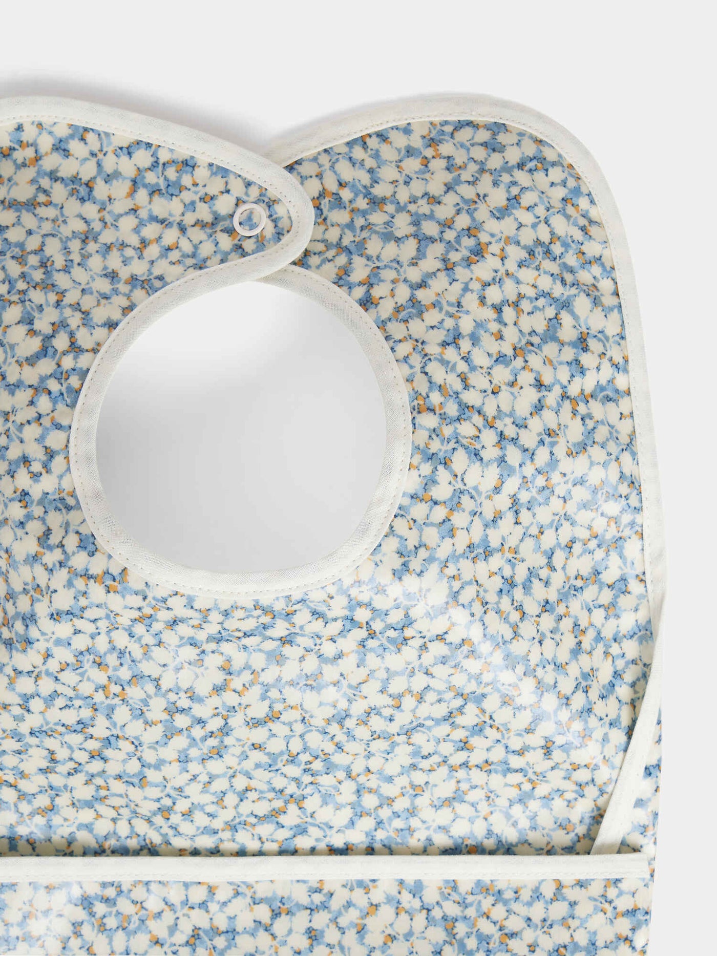Clip-on bib in blue Liberty fabric in coated organic cotton