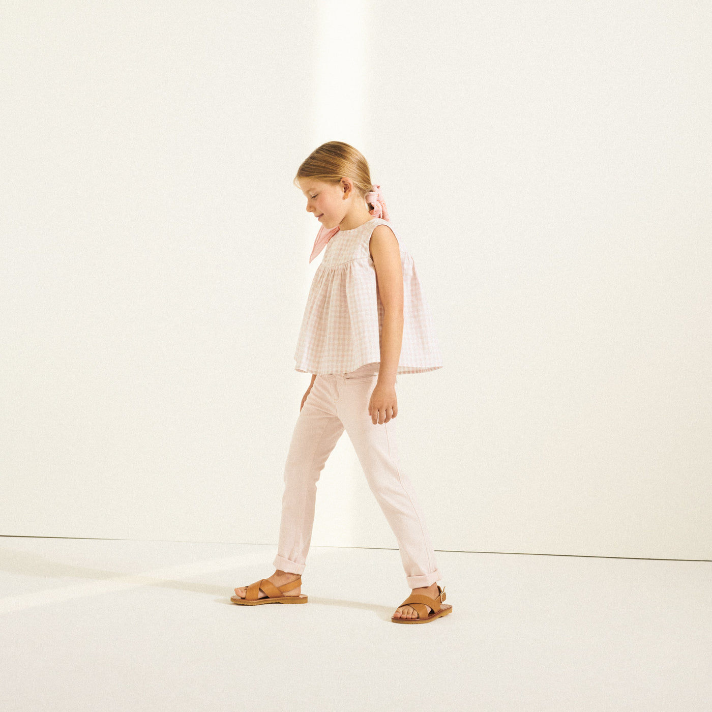 Girl in pale pink sleeveless blouse from Bonpoint Spring Summer 2022 Collection