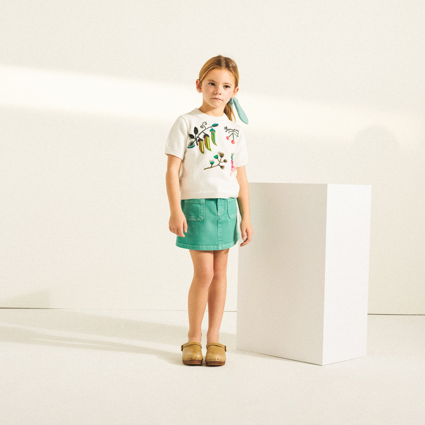 Girl in printed white shirt from Bonpoint Spring Summer 2022 Collection