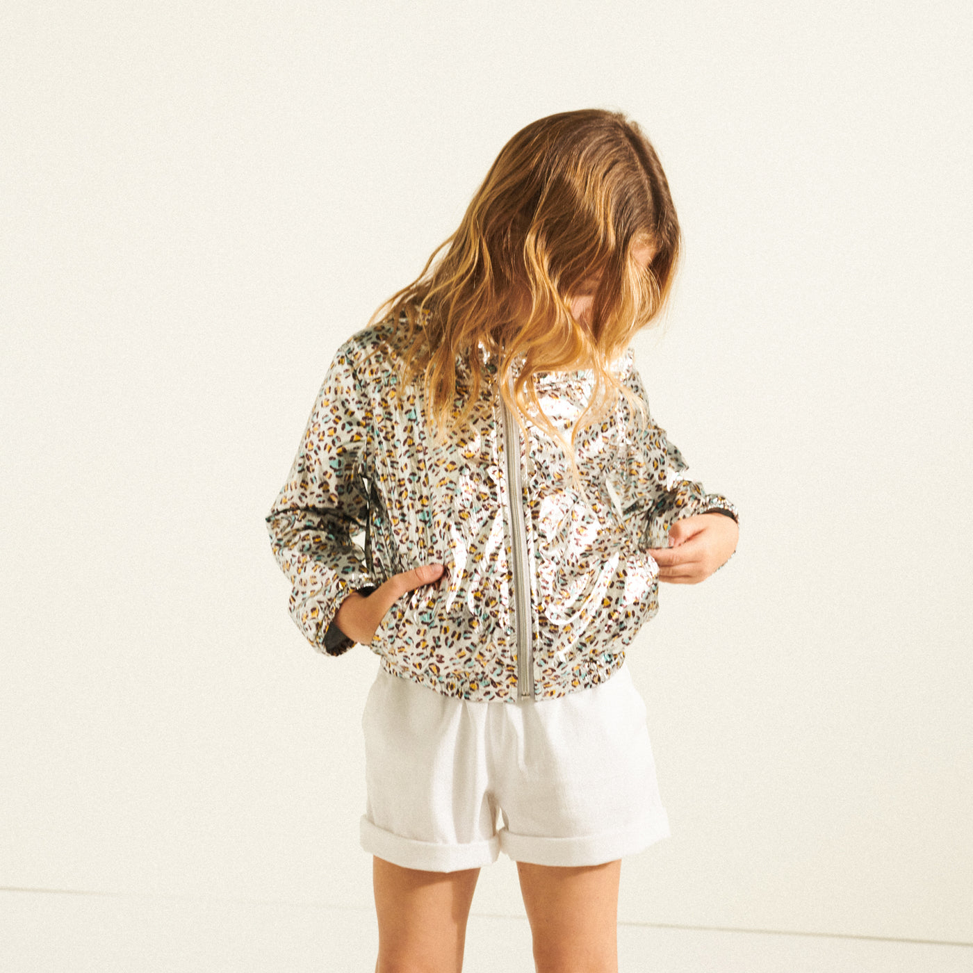 Girl in shiny cheetah print jacket from Bonpoint Spring Summer 2022 Collection