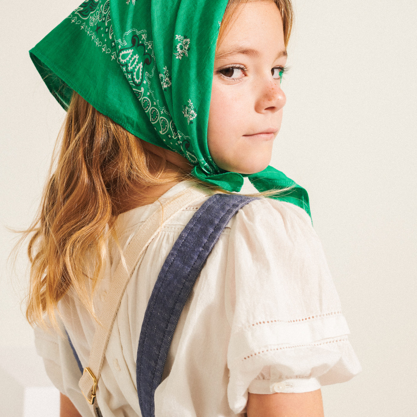 Bonpoint girl in green bandana and cream shirt