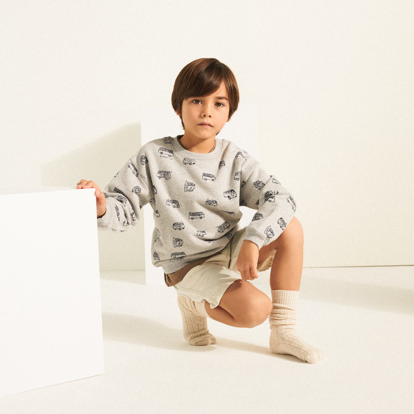Boy in graphic grey sweatshirt from Bonpoint Spring Summer 2022 Collection