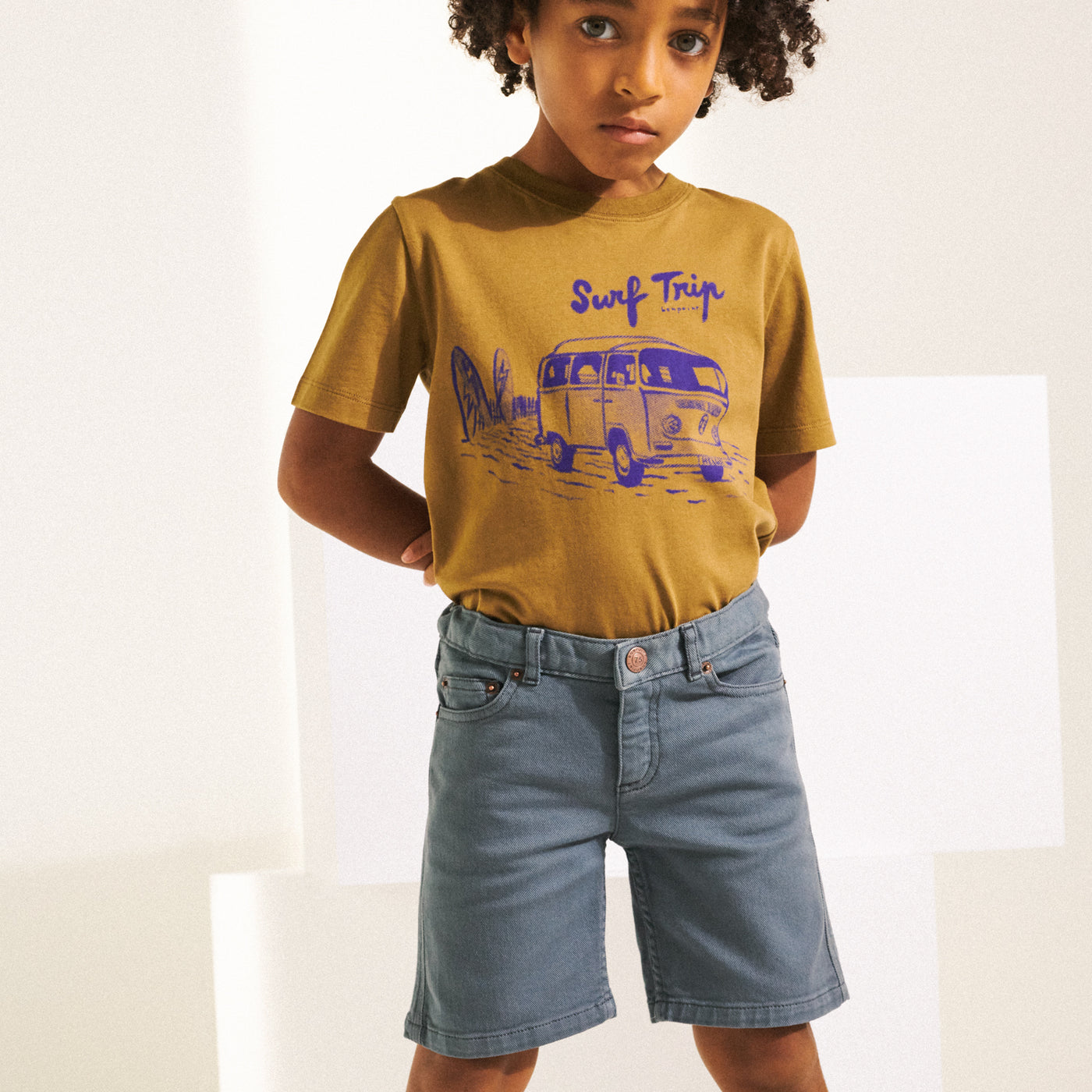 Boy in brown graphic shirt with blue detail from Bonpoint Spring Summer 2022 Collection
