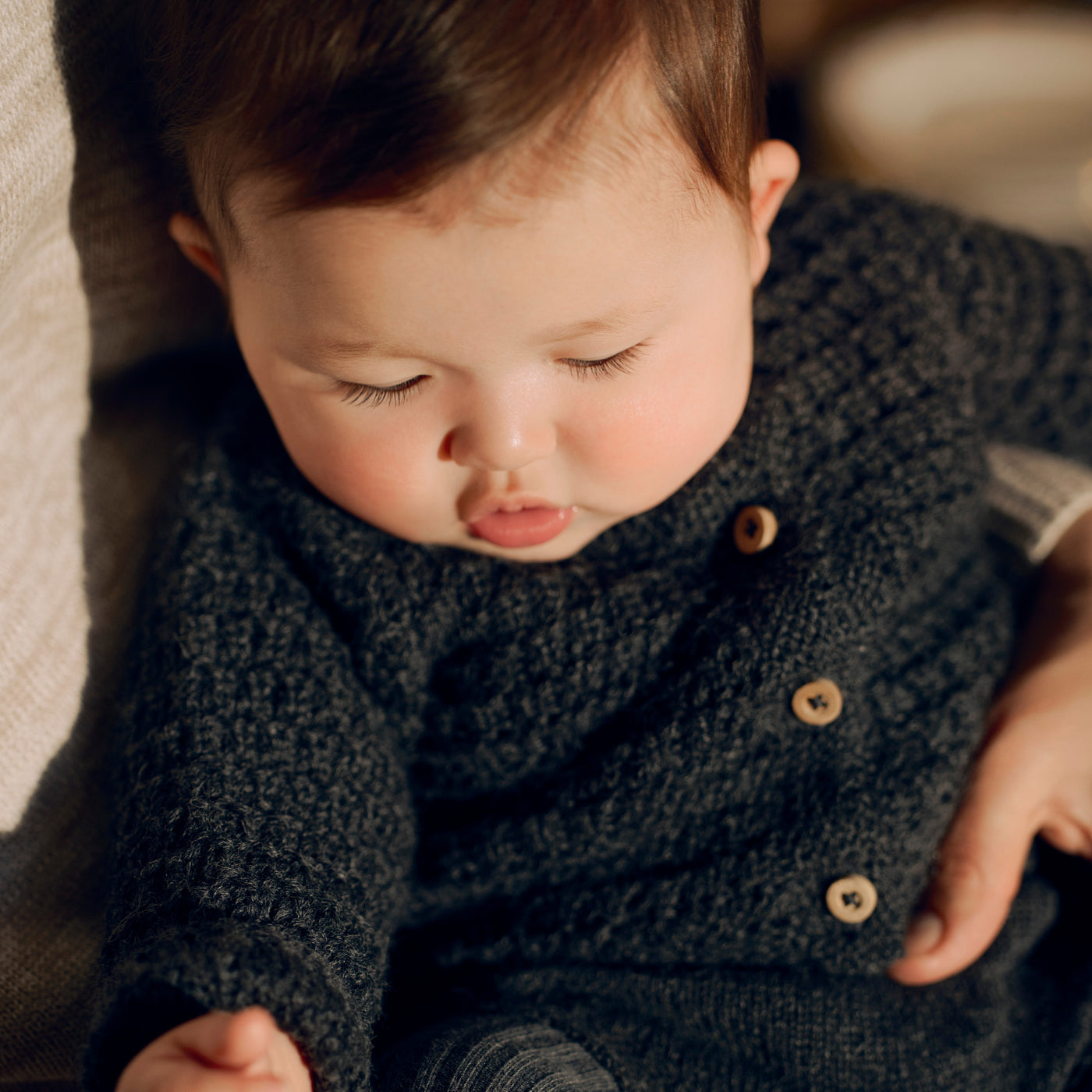 Bonpoint baby wearing knit button down sweater